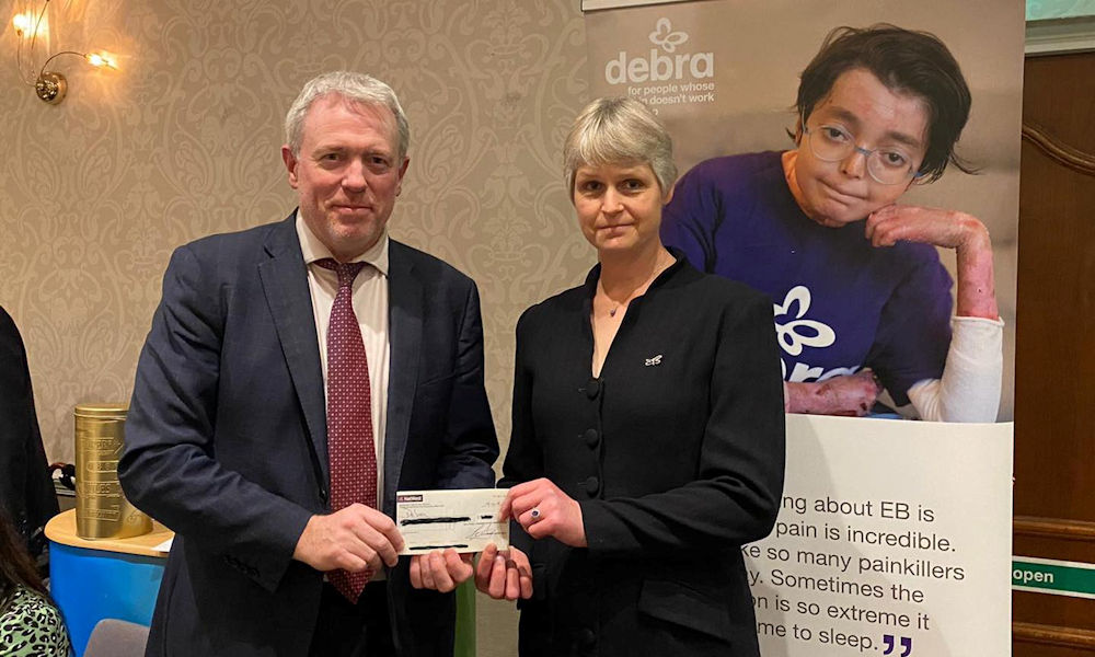 James Sunderland MP presents a cheque to Martha Desmond from Debra