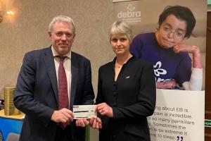 James Sunderland MP presents a cheque to Martha Desmond from Debra